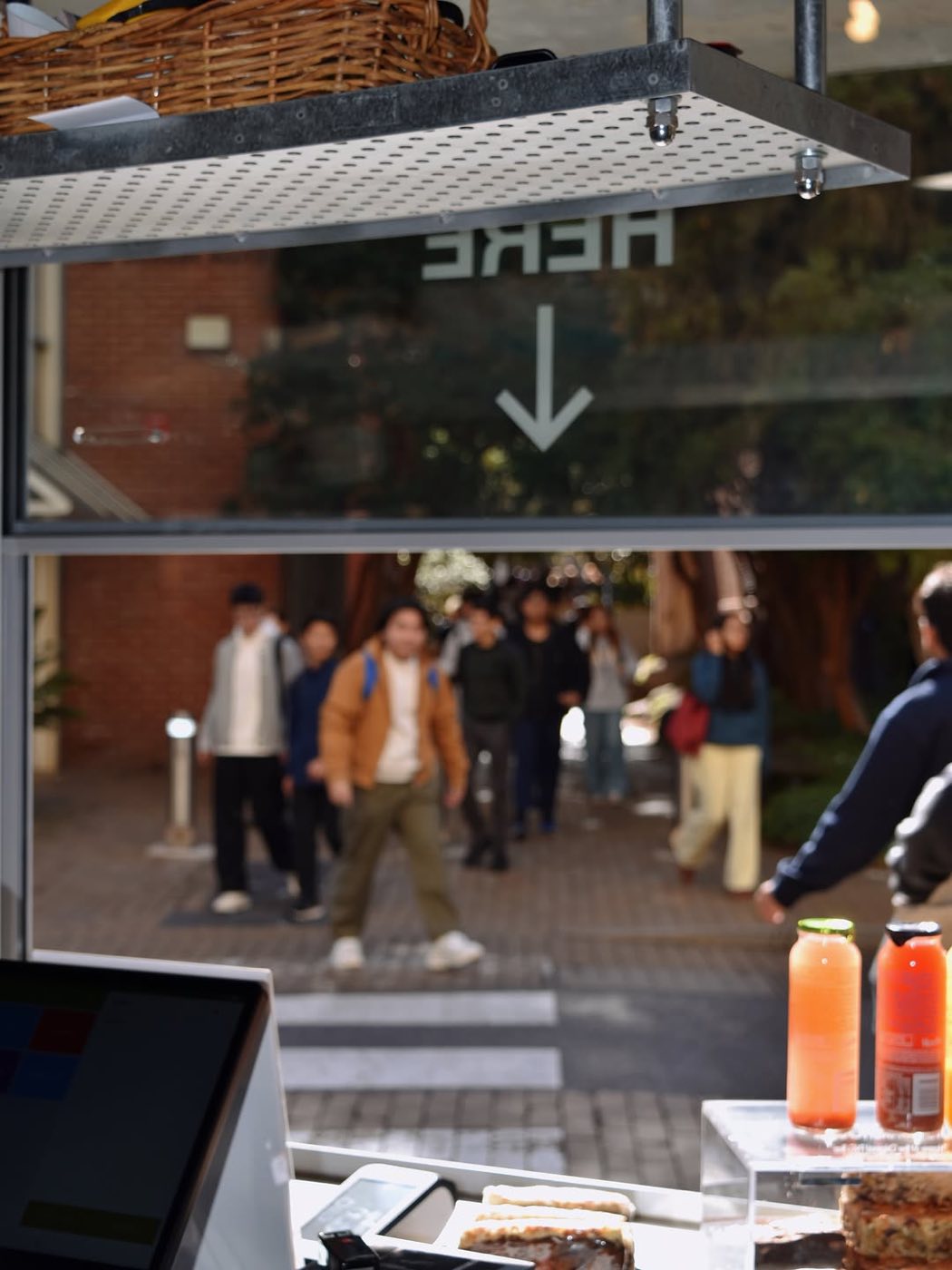 Students walking past the cafe window